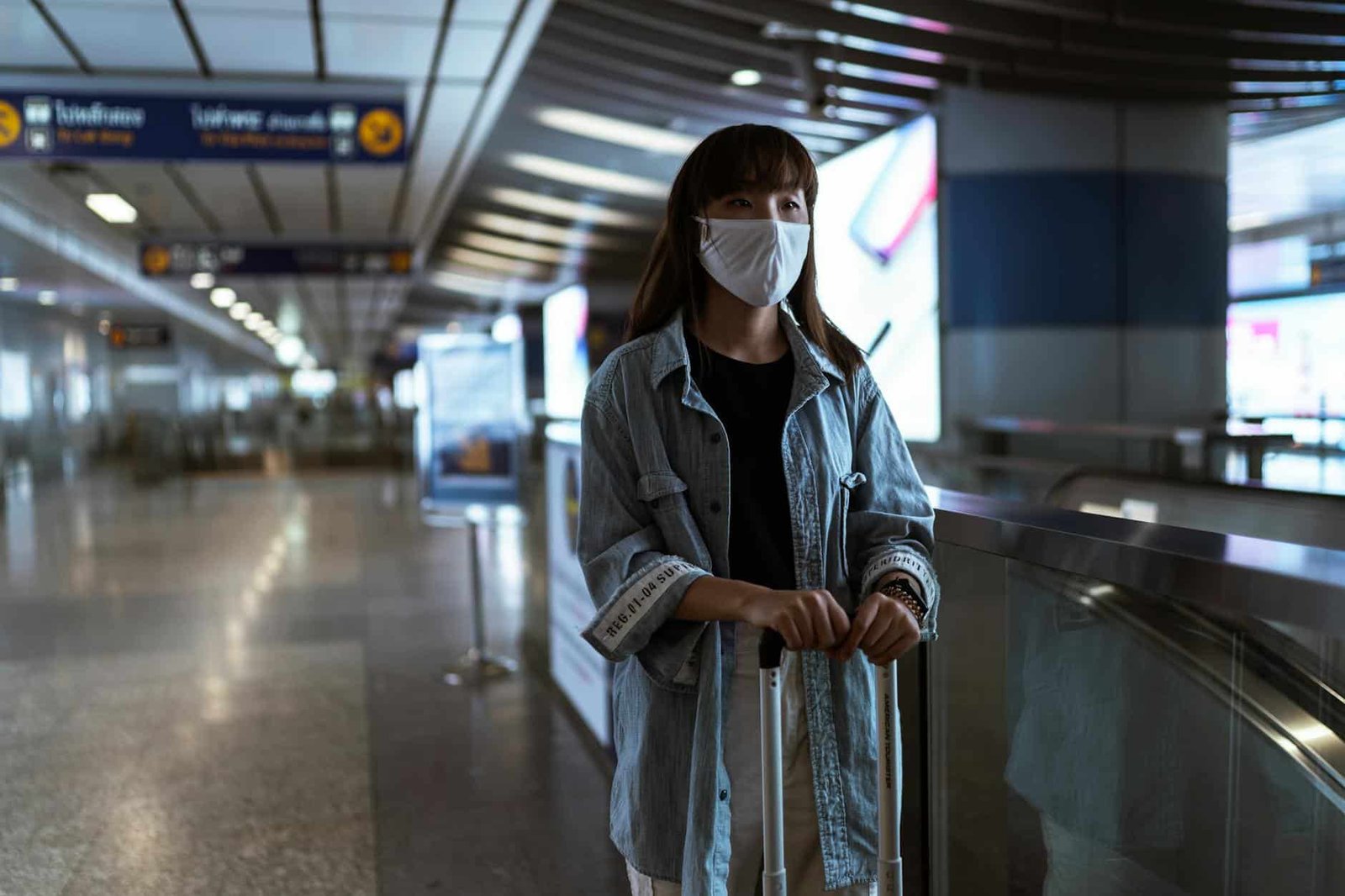 woman-wearing-a-face-mask-and-waiting-at-a-station-4436353/