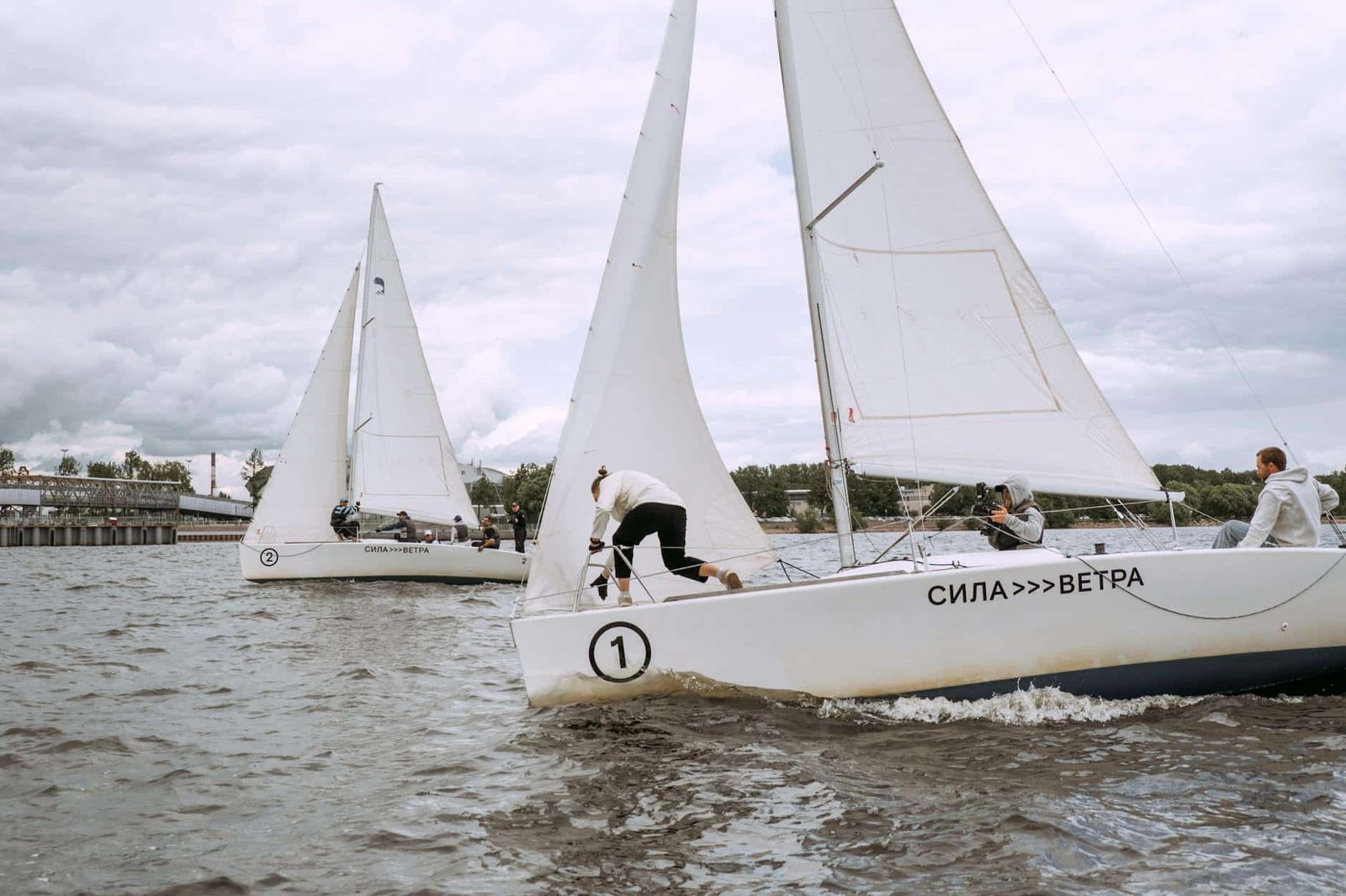 person-in-white-sail-boat-on-body-of-water-4934550/